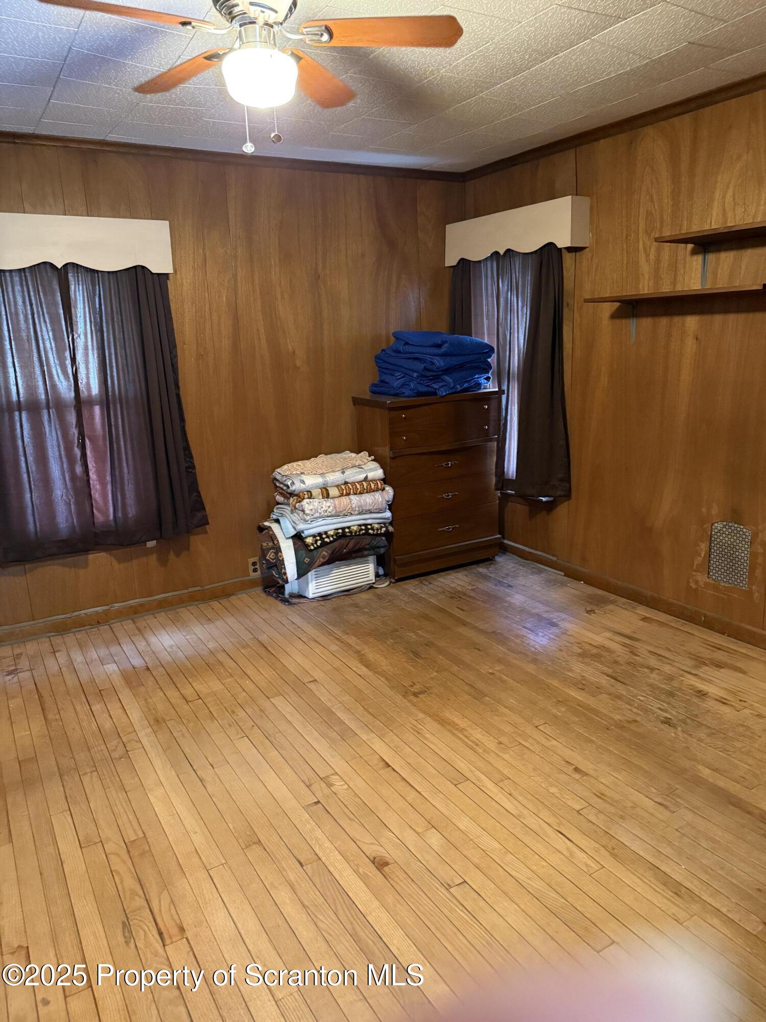 209 South Main Avenue Scranton, PA 18504 - Photo 11 of 21 a room with a bed and a chandelier