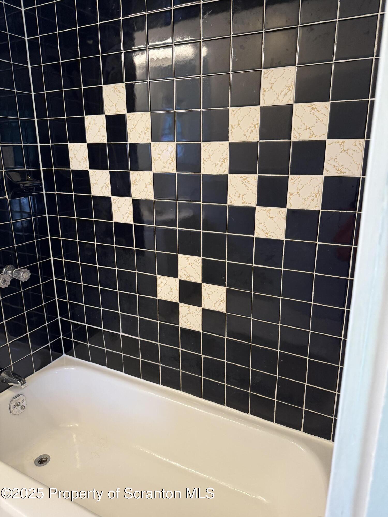 209 South Main Avenue Scranton, PA 18504 - Photo 14 of 21 a bathroom with a black white checkered and a blue shower