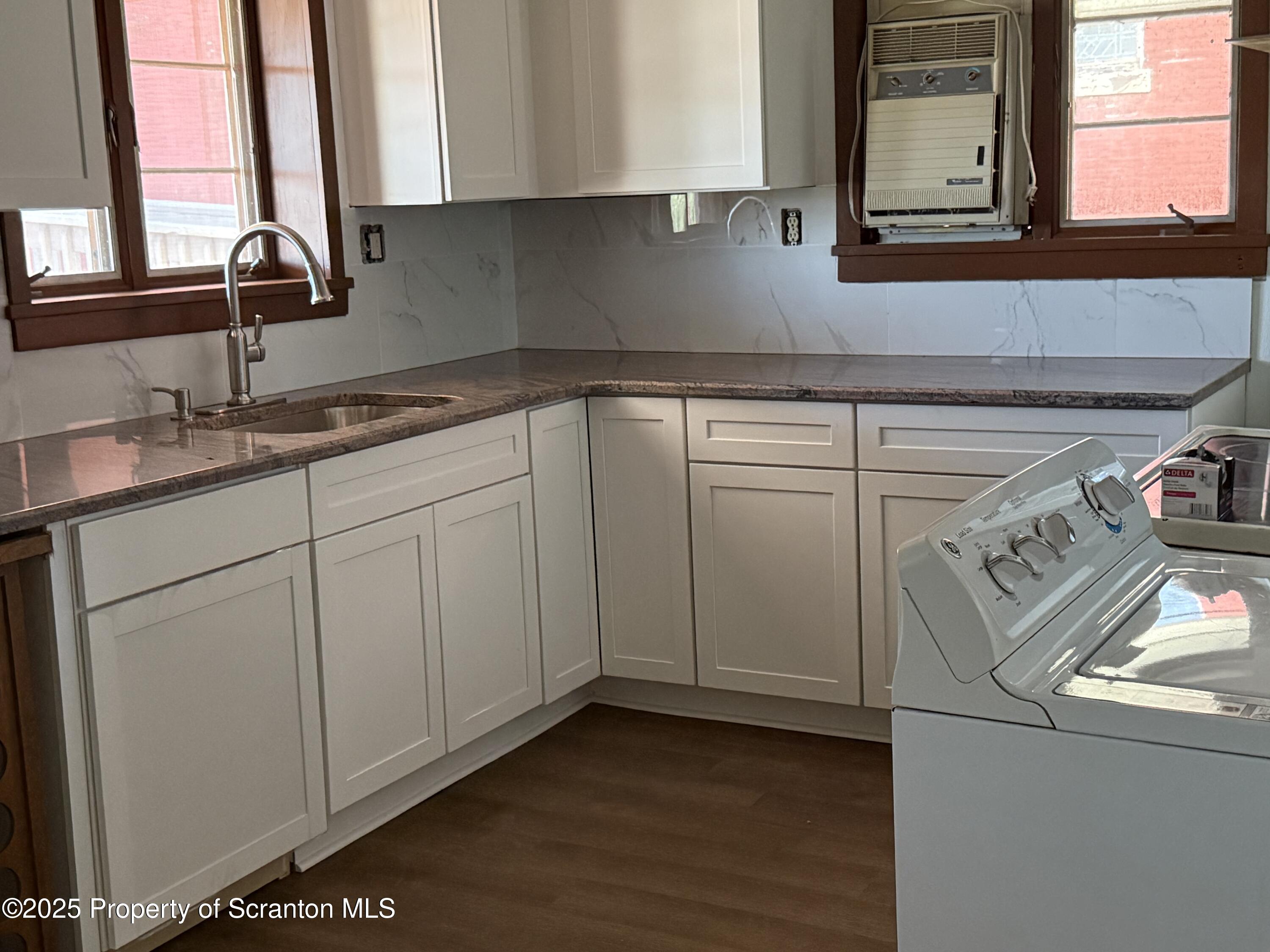 209 South Main Avenue Scranton, PA 18504 - Photo 3 of 21 a kitchen with white cabinets and a sink