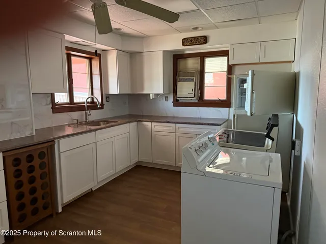 a kitchen with stainless steel appliances granite countertop a sink a stove and refrigerator