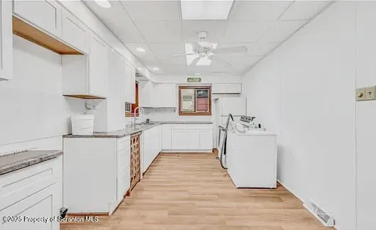 a kitchen with cabinets a sink and appliances
