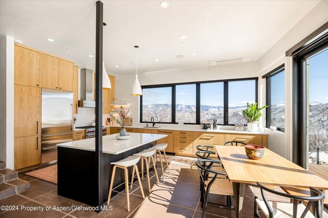 a dining table seating space with a large window