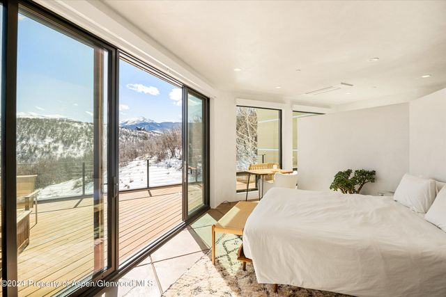 a view of a balcony with chair and floor to ceiling window