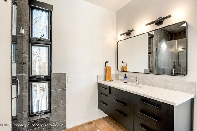 a bathroom with a sink and mirror
