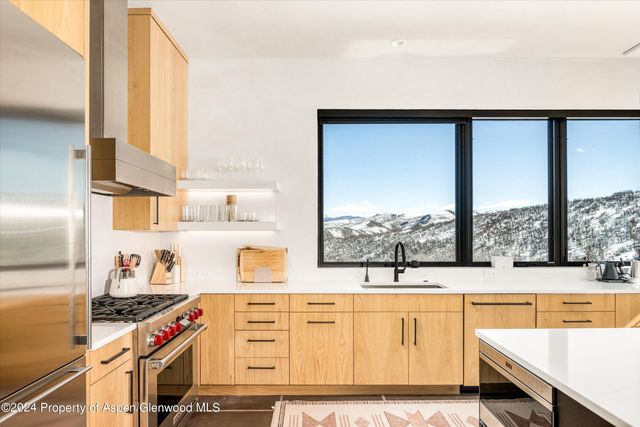 a living room with furniture and large windows