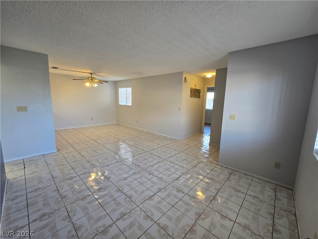 6750 Del Rey Avenue, Unit 133 Las Vegas, NV 89146 - Photo 7 of 34 A spacious living area featuring tiled flooring and abundant natural light.