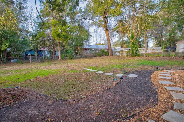 a backyard of a house with barbeque oven fire pit table and chairs