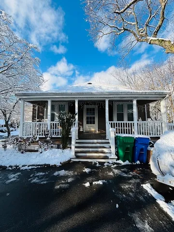 a front view of a house with yard and balcony