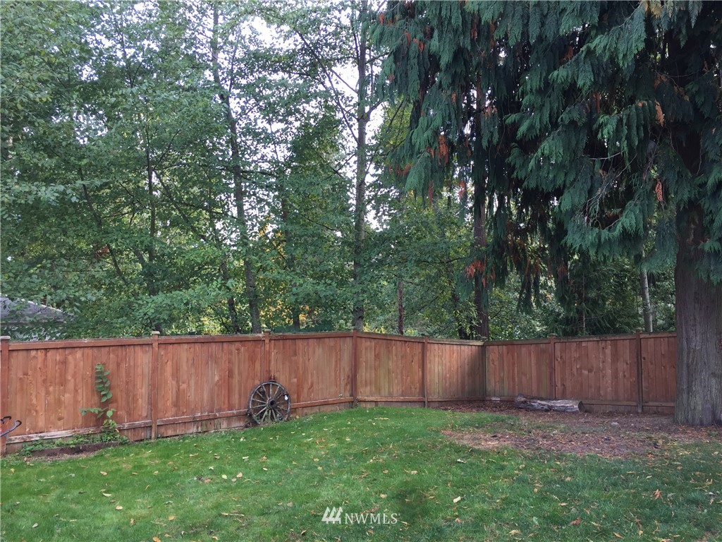 7531 Lower Ridge Road Everett, WA 98203 - Photo 22 of 25 a view of a backyard with a small cabin and wooden fence