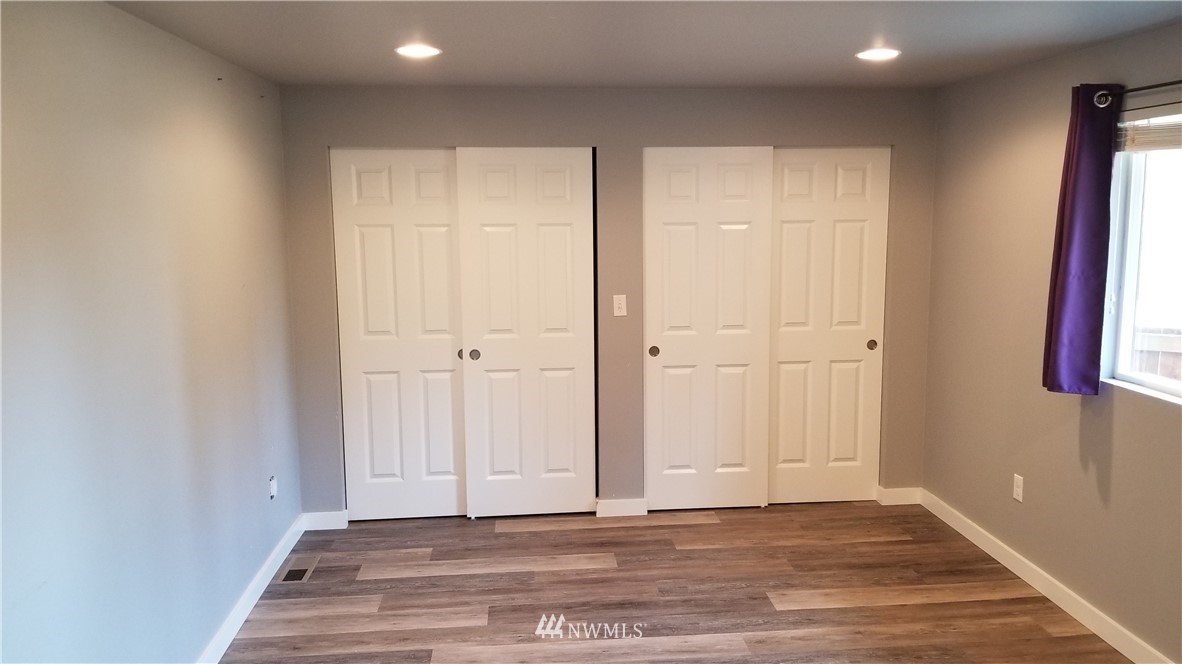 7531 Lower Ridge Road Everett, WA 98203 - Photo 8 of 25 a view of a livingroom with wooden floor and closet