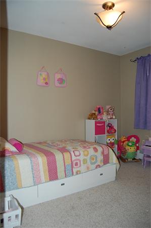 7 Old County Road Ware, MA 01082 - Photo 8 of 16 a bedroom with a bed and a chandelier