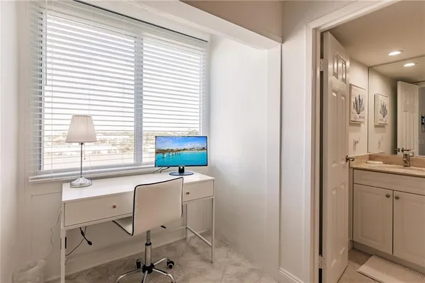a view of a bathroom with a sink a mirror and a window