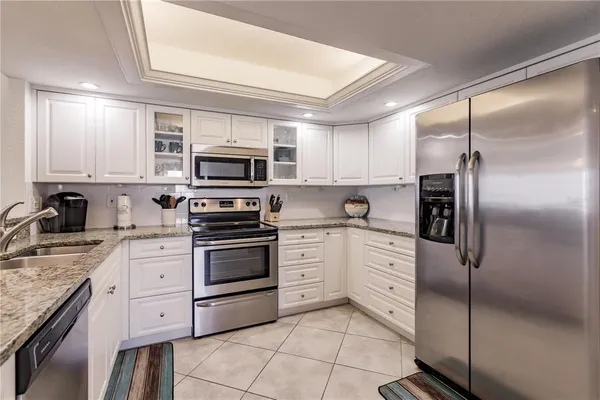 a kitchen with cabinets stainless steel appliances and a counter top space