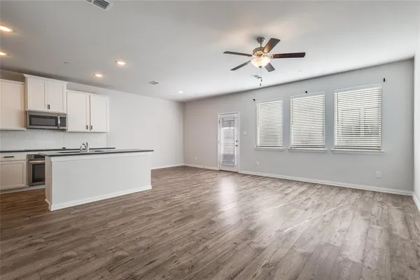 a view of kitchen with wooden floor and window