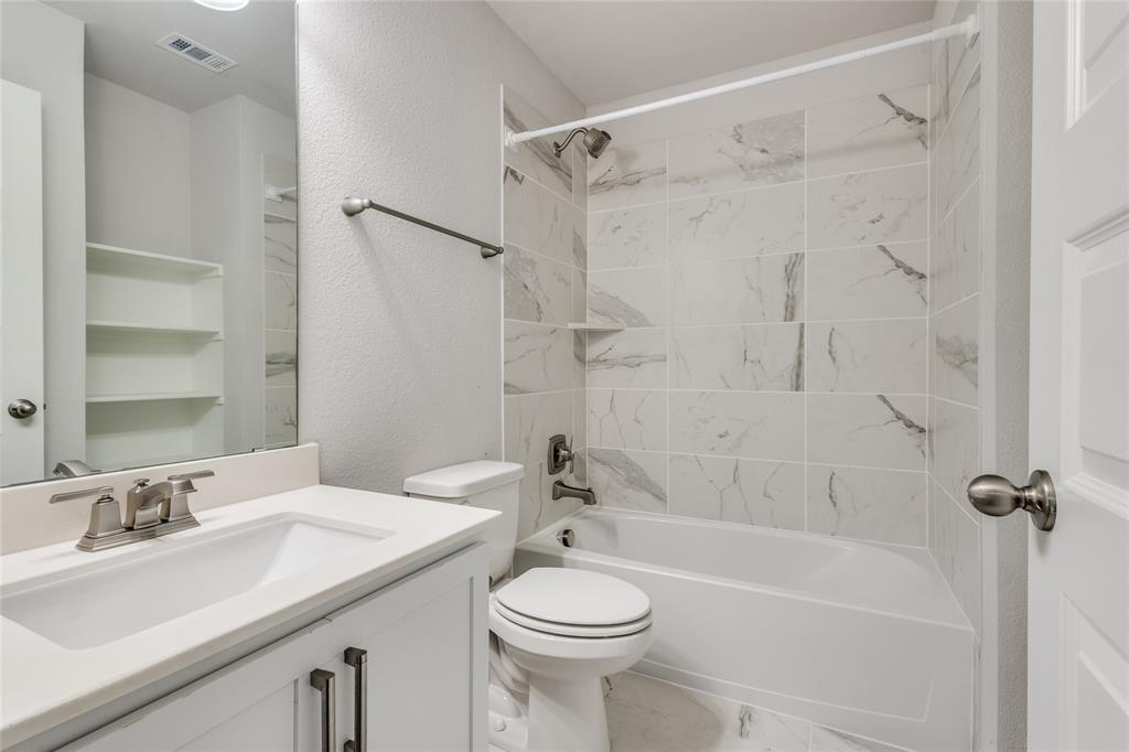 1118 Houston Way Lewisville, TX 75077 - Photo 9 of 12 a bathroom with a sink toilet and shower