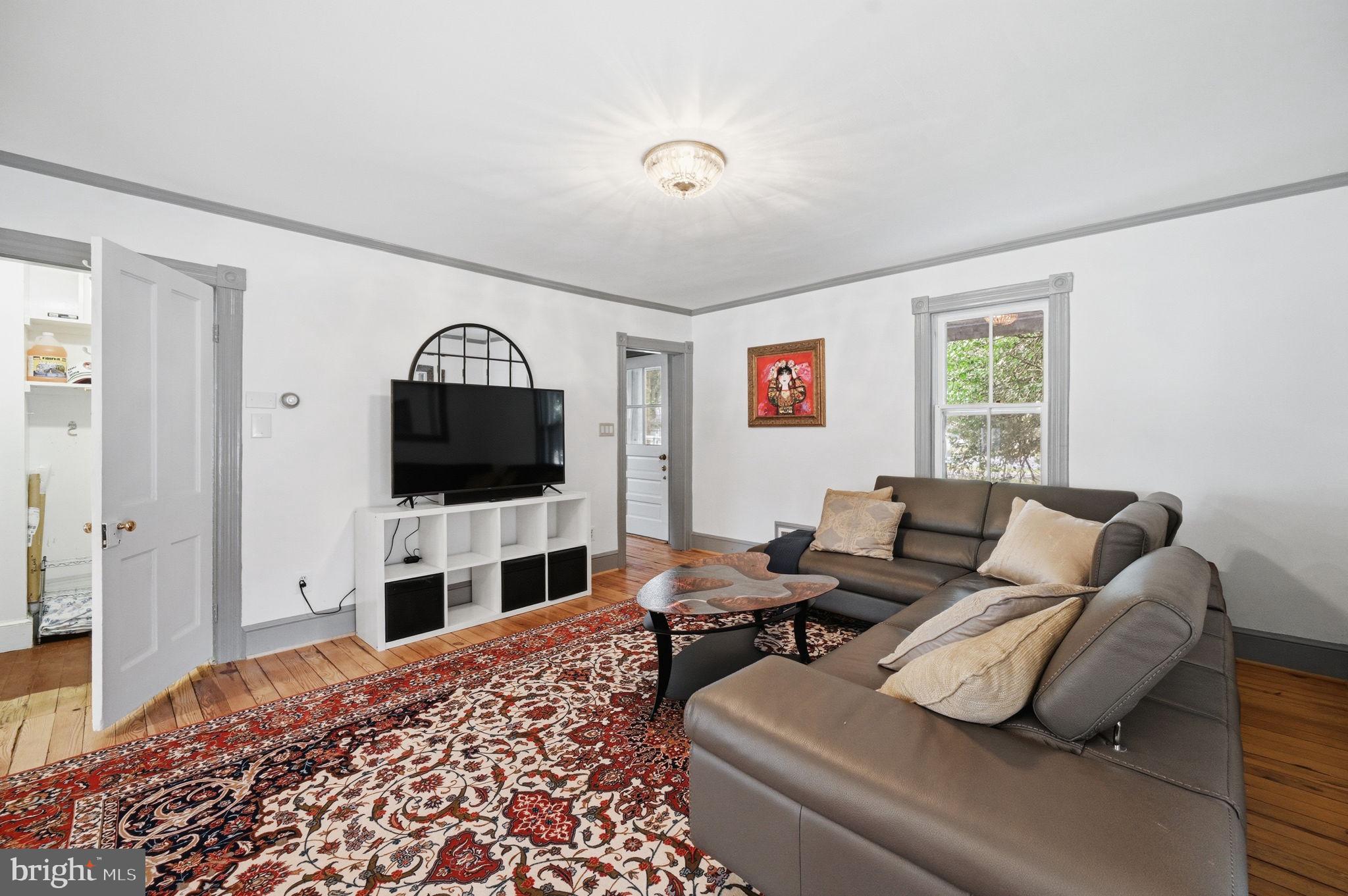 11641 Glen Road Potomac, MD 20854 - Photo 7 of 40 a living room with furniture and a flat screen tv