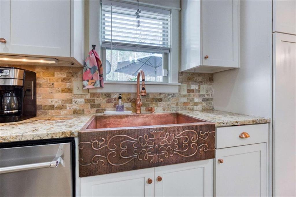 1948 Hearthstone Court Winder, GA 30680 - Photo 27 of 87 a kitchen with stainless steel appliances granite countertop a sink stove and cabinets