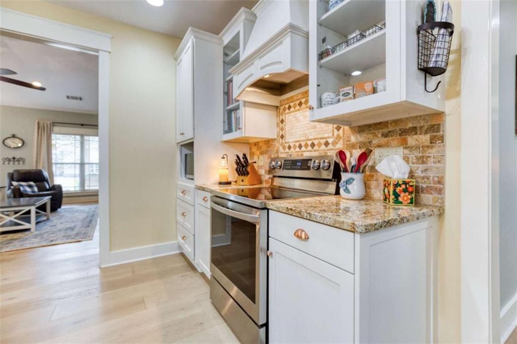 1948 Hearthstone Court Winder, GA 30680 - Photo 28 of 87 a kitchen with stainless steel appliances granite countertop a stove and a sink