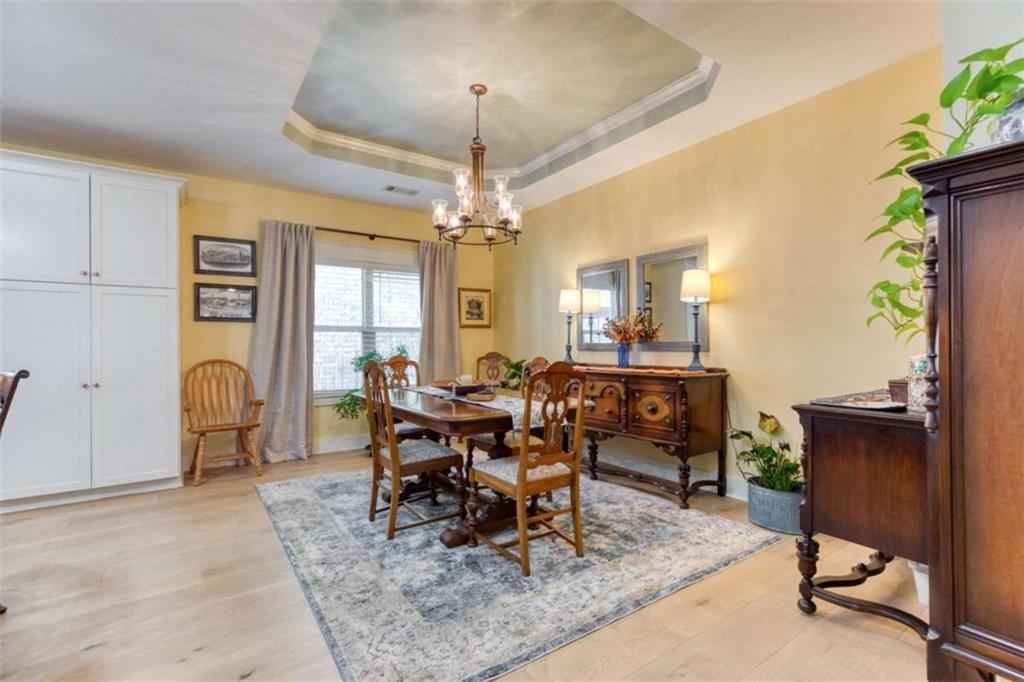 1948 Hearthstone Court Winder, GA 30680 - Photo 29 of 87 a dining room with wooden floor and chandelier