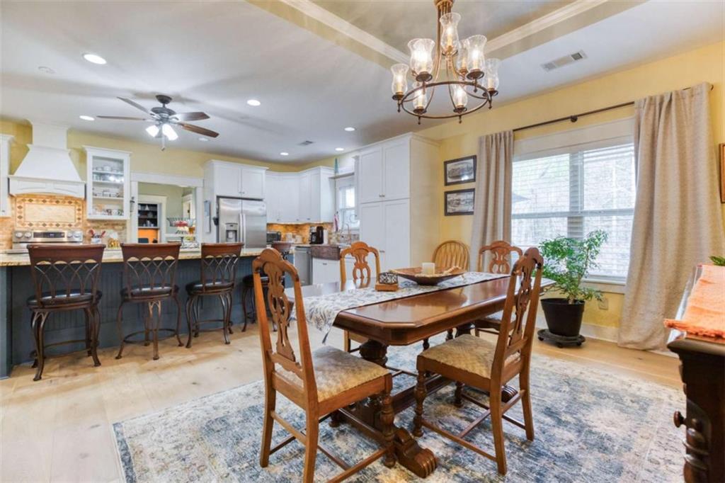 1948 Hearthstone Court Winder, GA 30680 - Photo 31 of 87 a view of a dining room with furniture and a chandelier