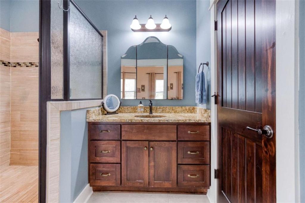 1948 Hearthstone Court Winder, GA 30680 - Photo 50 of 87 a bathroom with a sink and a mirror