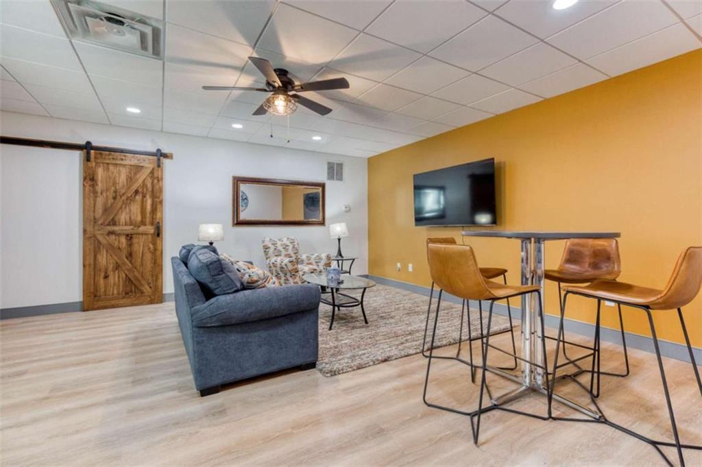 1948 Hearthstone Court Winder, GA 30680 - Photo 62 of 87 a living room with furniture and a flat screen tv