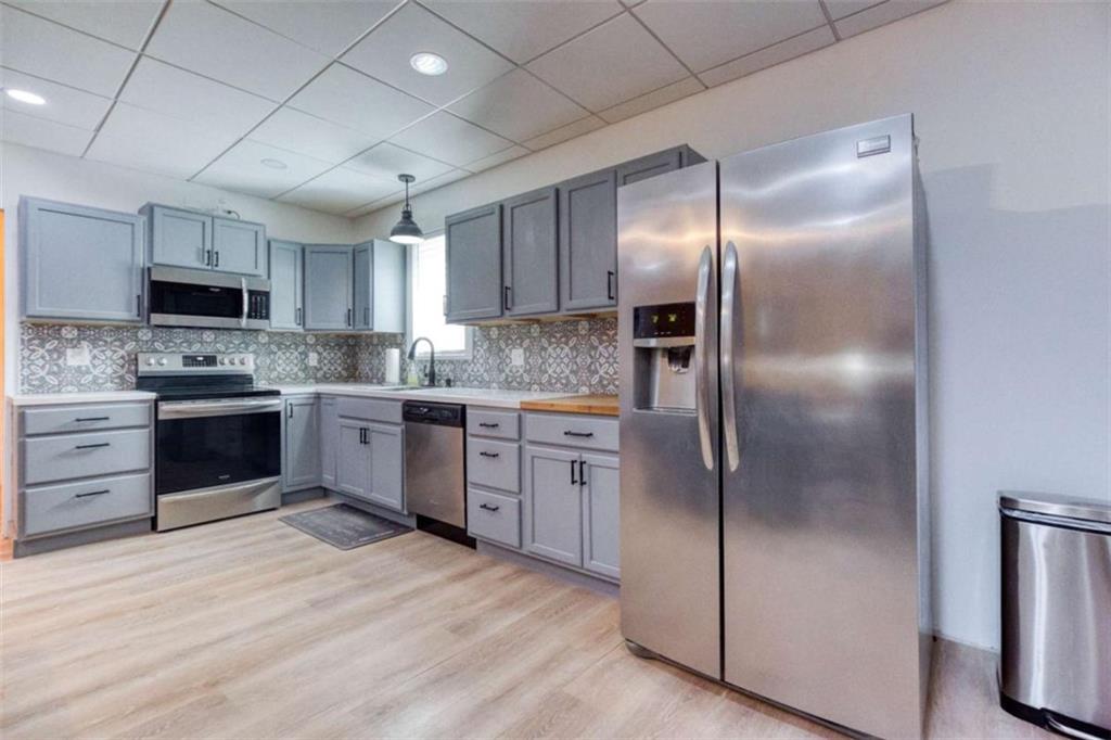 1948 Hearthstone Court Winder, GA 30680 - Photo 65 of 87 a kitchen with kitchen island granite countertop stainless steel appliances cabinets a sink and a window