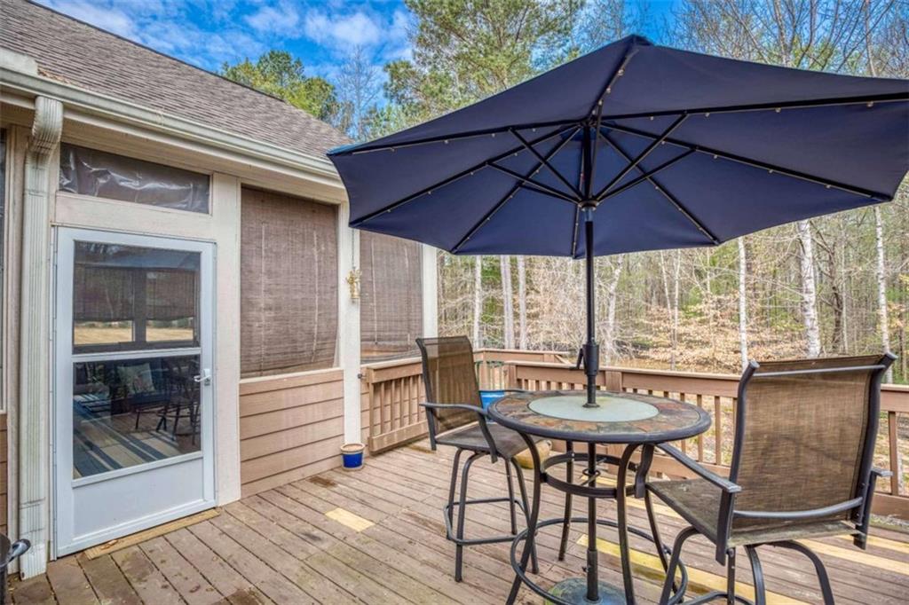 1948 Hearthstone Court Winder, GA 30680 - Photo 78 of 87 a view of a patio with table and chairs under an umbrella
