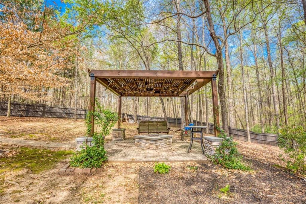 1948 Hearthstone Court Winder, GA 30680 - Photo 82 of 87 a patio with glass top table and chairs