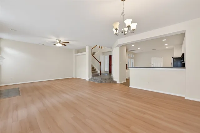 a kitchen with stainless steel appliances granite countertop white cabinets a stove a microwave and a refrigerator