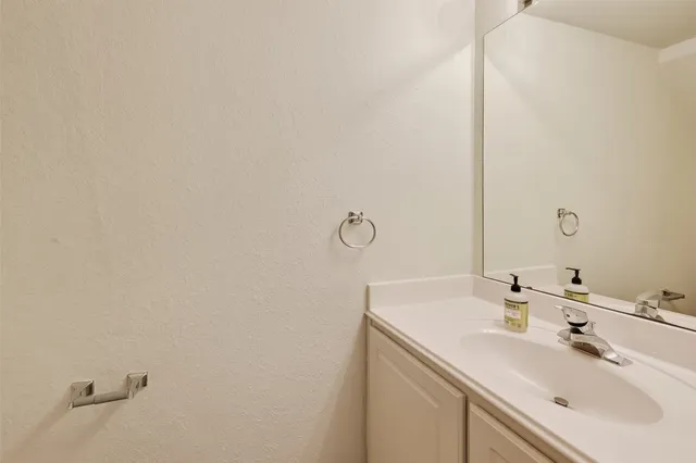 a view of an empty room with a fireplace and a window
