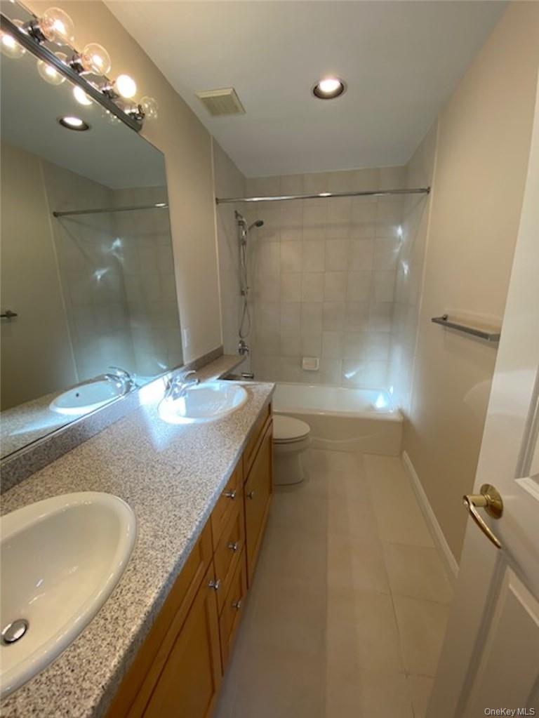 51 Winding Ridge Road White Plains, NY 10603 - Photo 18 of 30 a bathroom with a granite countertop sink a toilet a mirror and shower