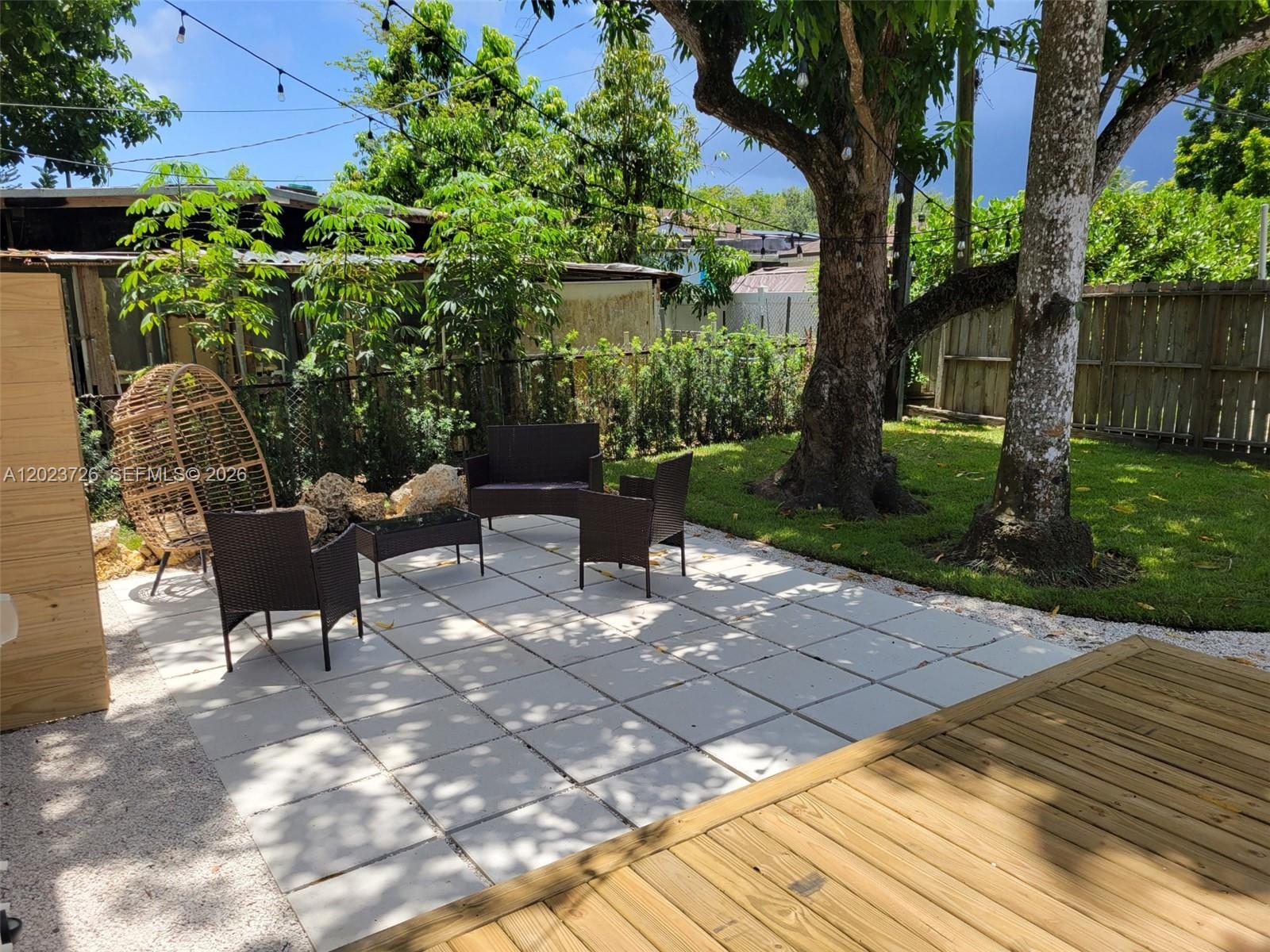 5866 Southwest 60th Street, Unit 3 Miami, FL 33143 - Photo 6 of 8 a view of a chairs and table in the garden