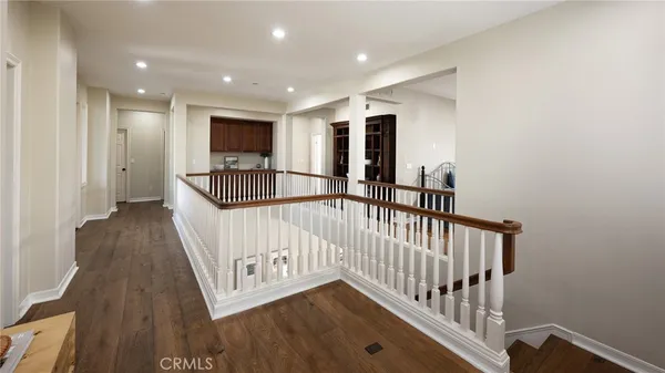 a view of hallway with wooden floor