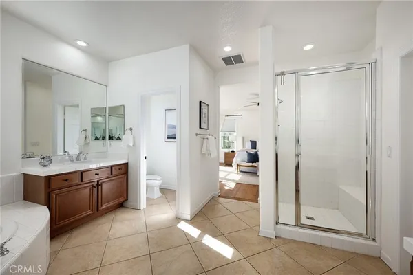 a bathroom with a glass door shower a sink and a mirror