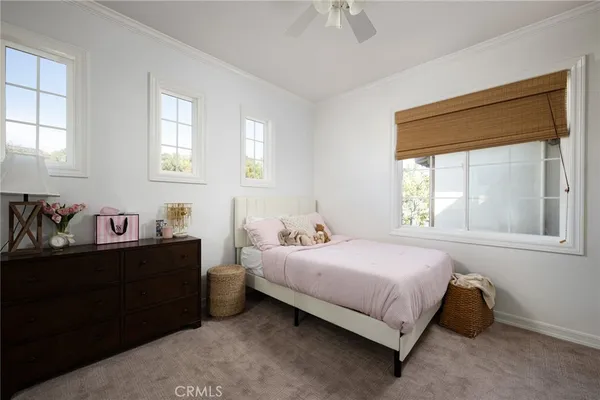 a bedroom with a bed dresser and a window
