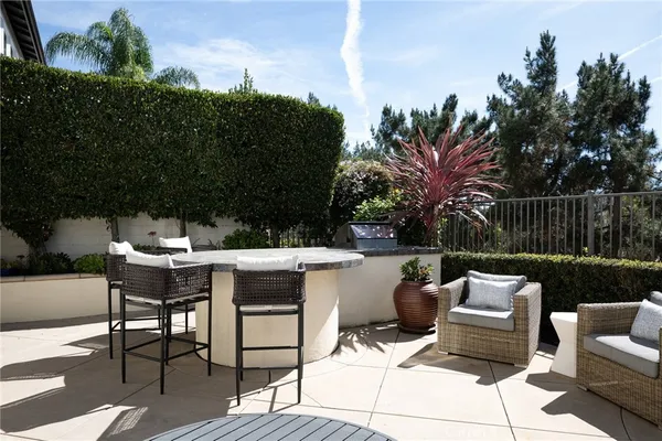 a view of a patio with couches table and chairs and potted plants