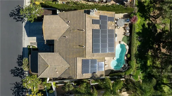 an aerial view of a house with garden space and plants