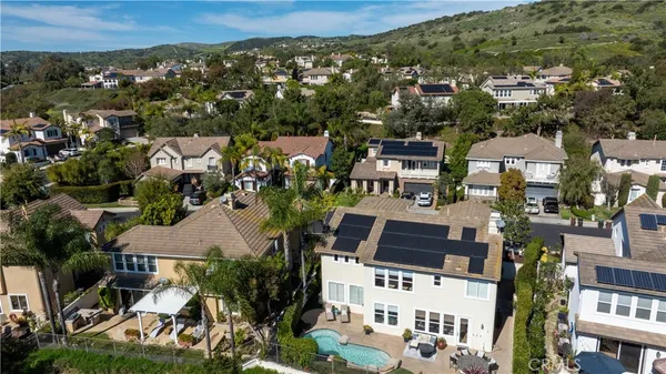 an aerial view of a house with a yard and lake view