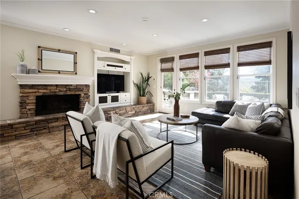 a living room with furniture flat screen tv and a fireplace