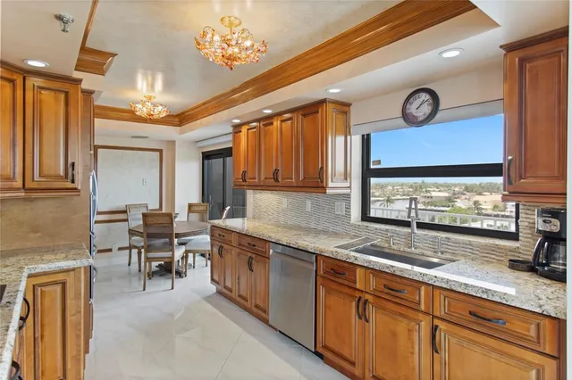 a kitchen with stainless steel appliances granite countertop a sink and cabinets
