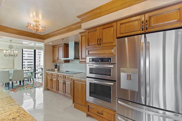 a kitchen with stainless steel appliances a stove refrigerator and cabinets