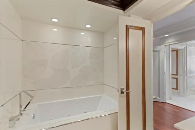 a bathroom with a sink a toilet a mirror and shower