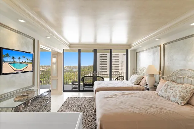 a bedroom with a large bed and a large window