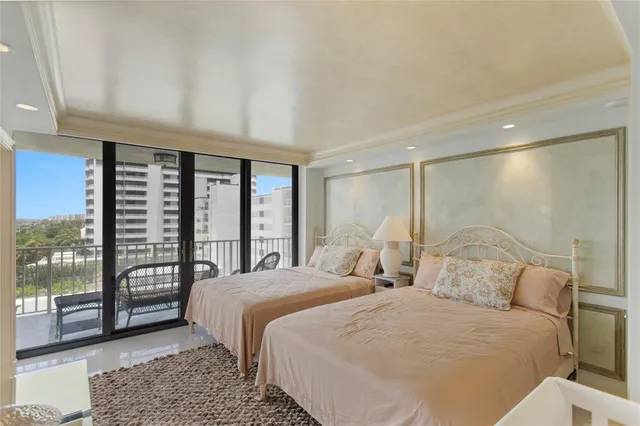 a bedroom with two beds and a window