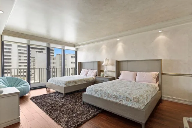 a bedroom with furniture and large windows