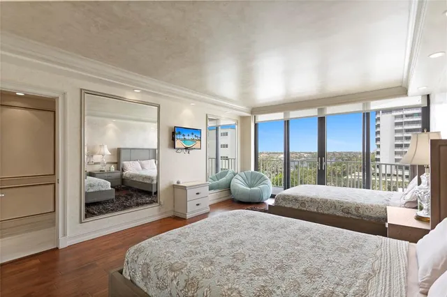 a bedroom with two beds and painting on the wall