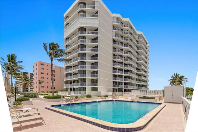 a view of a chair and table on the roof deck
