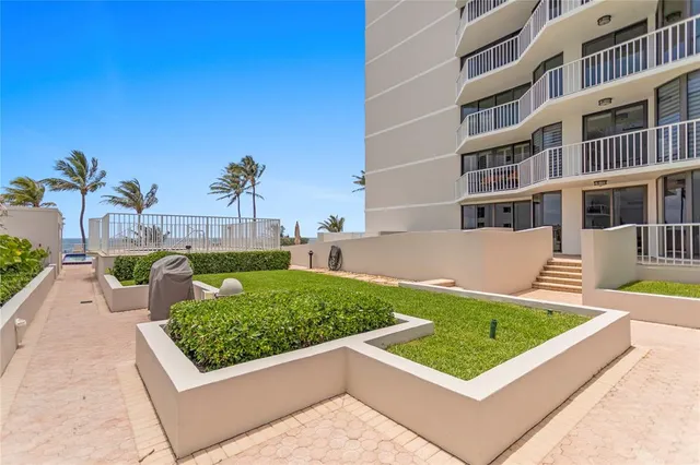 a view of a city with tall buildings and a big yard