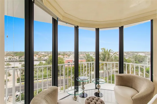 a living room with a large window and a floor to ceiling window